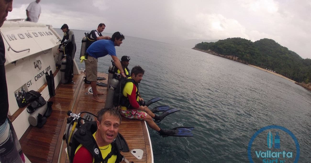 Scuba group preparing on dive boat off coastal island