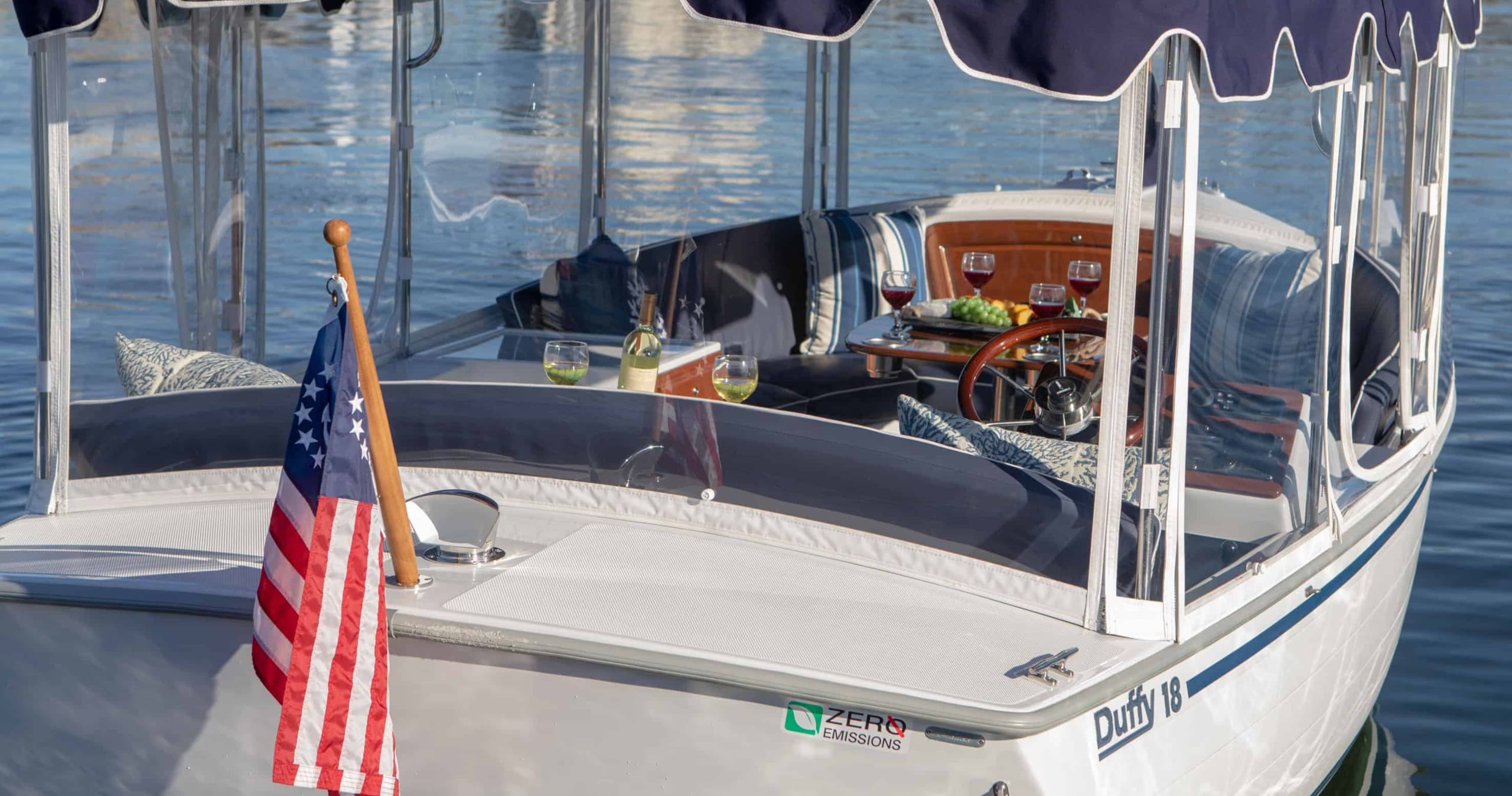 Covered boat bow with American flag docked in marina