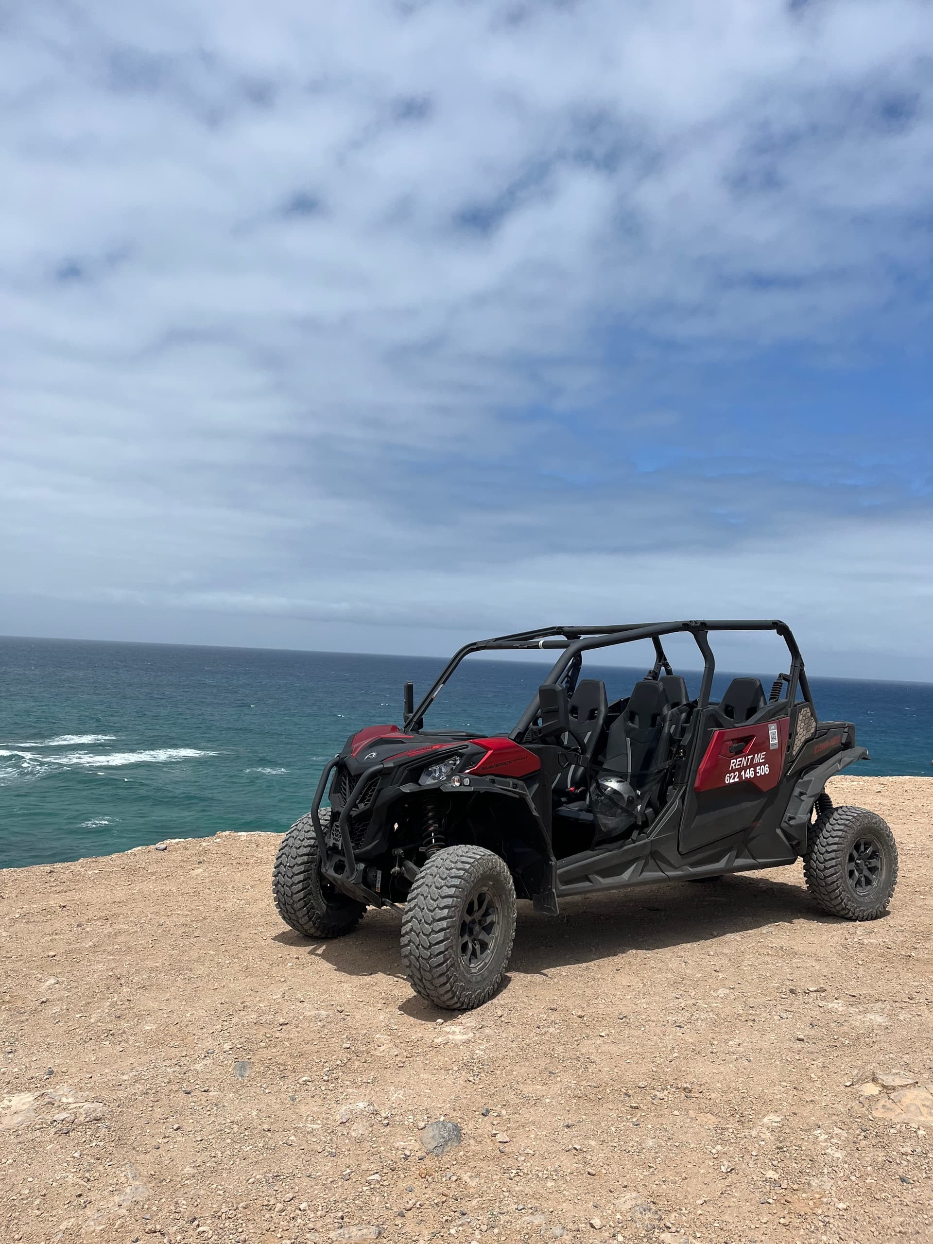 Utility terrain vehicle parked on cliff overlooking Atlantic near Fuerteventura