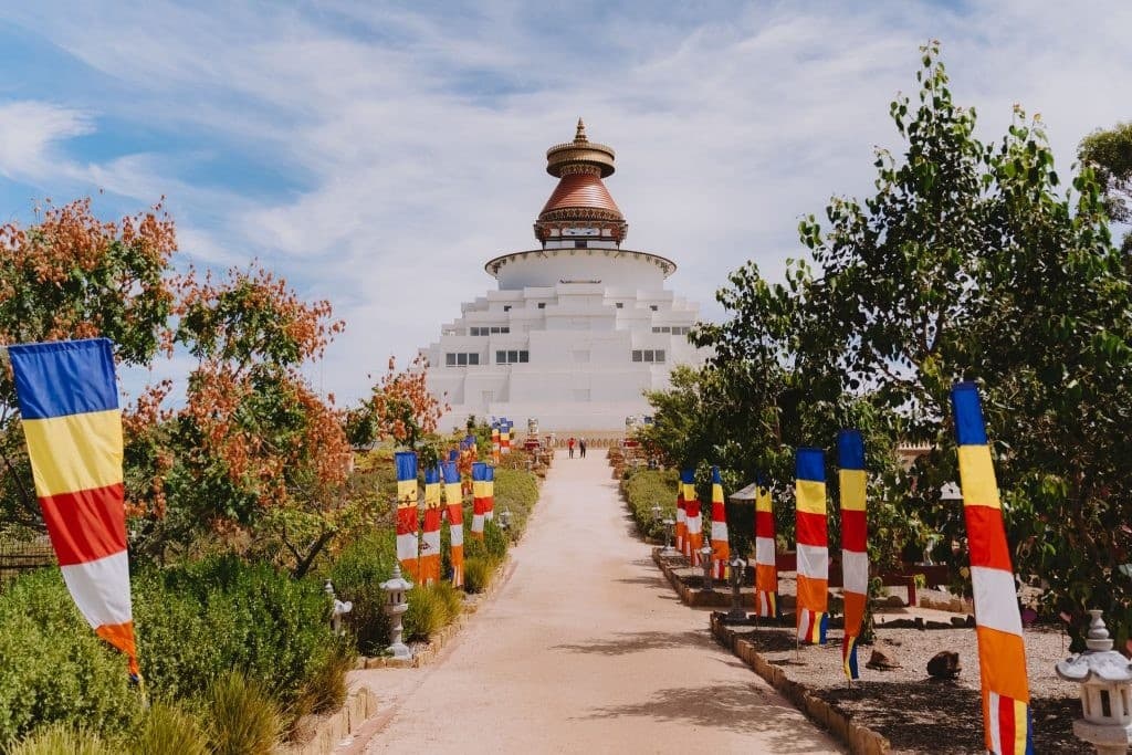 Flag-lined approach path leading to Great Stupa of Universal Compassion