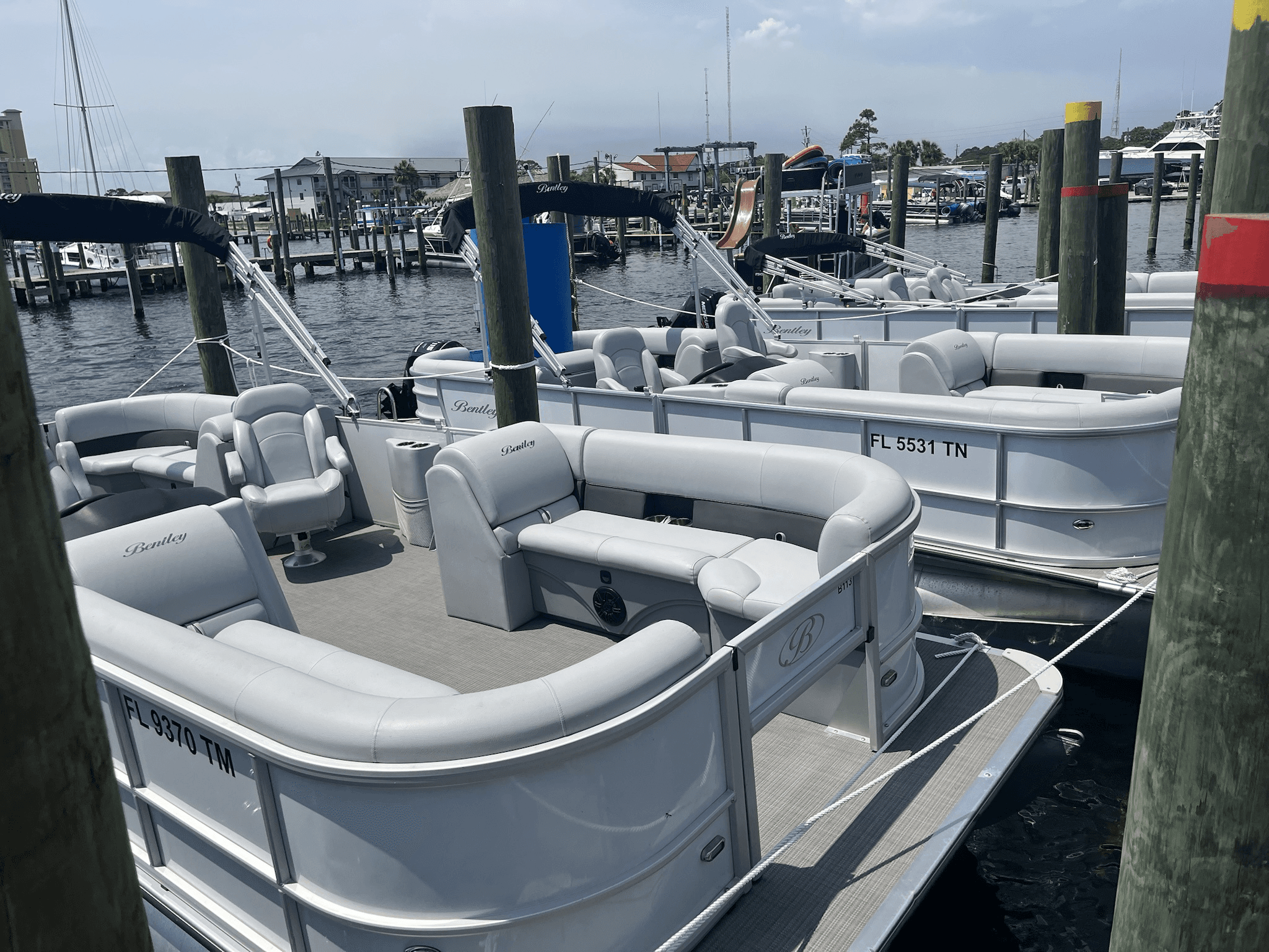 Pontoon boats docked at marina for coastal boat rentals