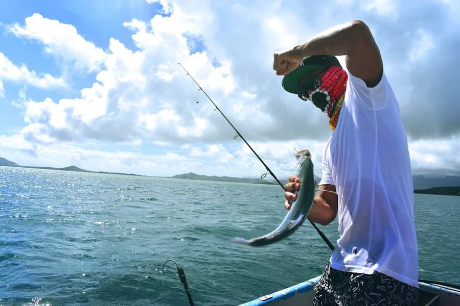 Angler reeling fish from charter boat on open ocean