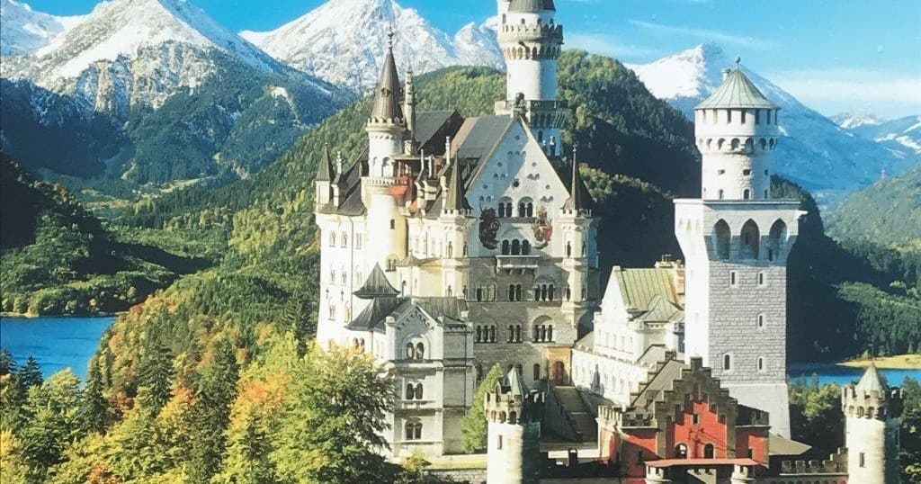 Neuschwanstein Castle lakeside panorama with alpine mountains view
