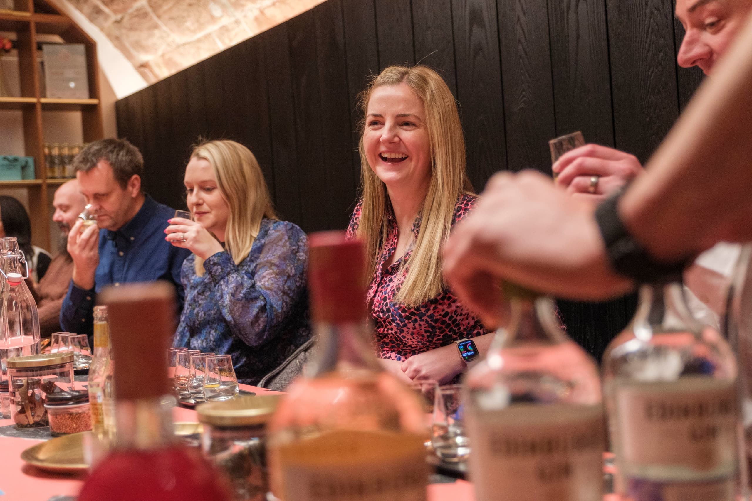 Guests enjoying gin tasting experience at Edinburgh distillery