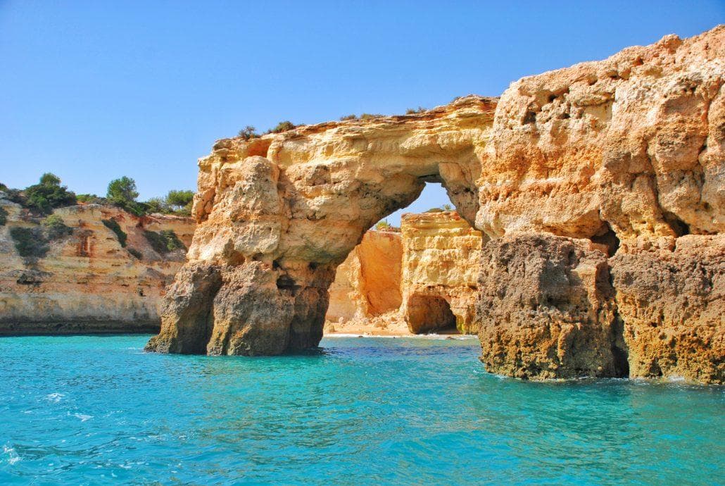 Dramatic Algarve limestone arch and turquoise sea, scenic cruise