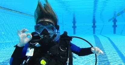 Scuba trainee practicing skills underwater in pool