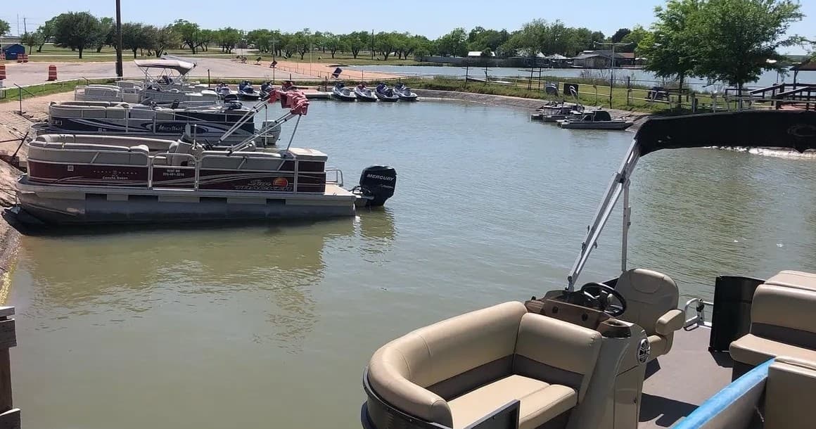 View from pontoon deck overlooking rental boats moored in marina
