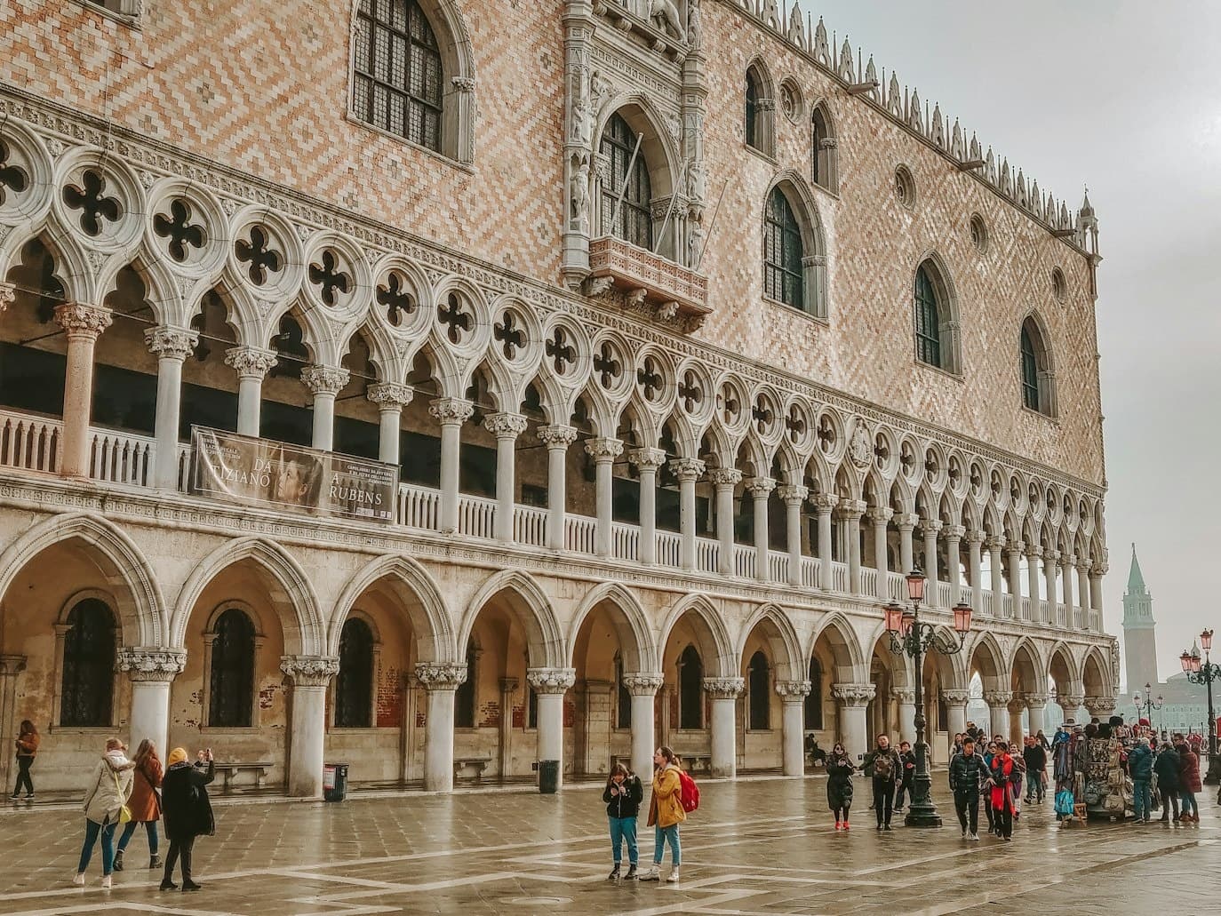 St Mark's Square tourists admiring Doge's Palace facade, Venice