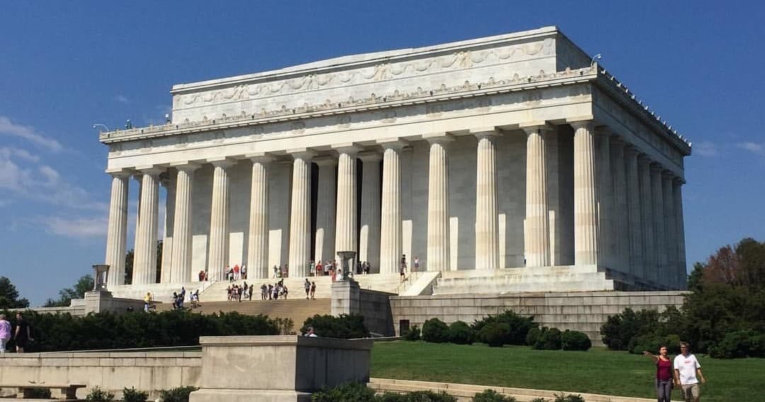 Lincoln Memorial facade and reflecting pool at sunrise in Washington DC