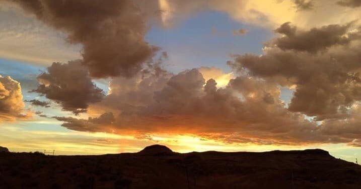 Sunset over Monument Valley mesa with dramatic colorful skies