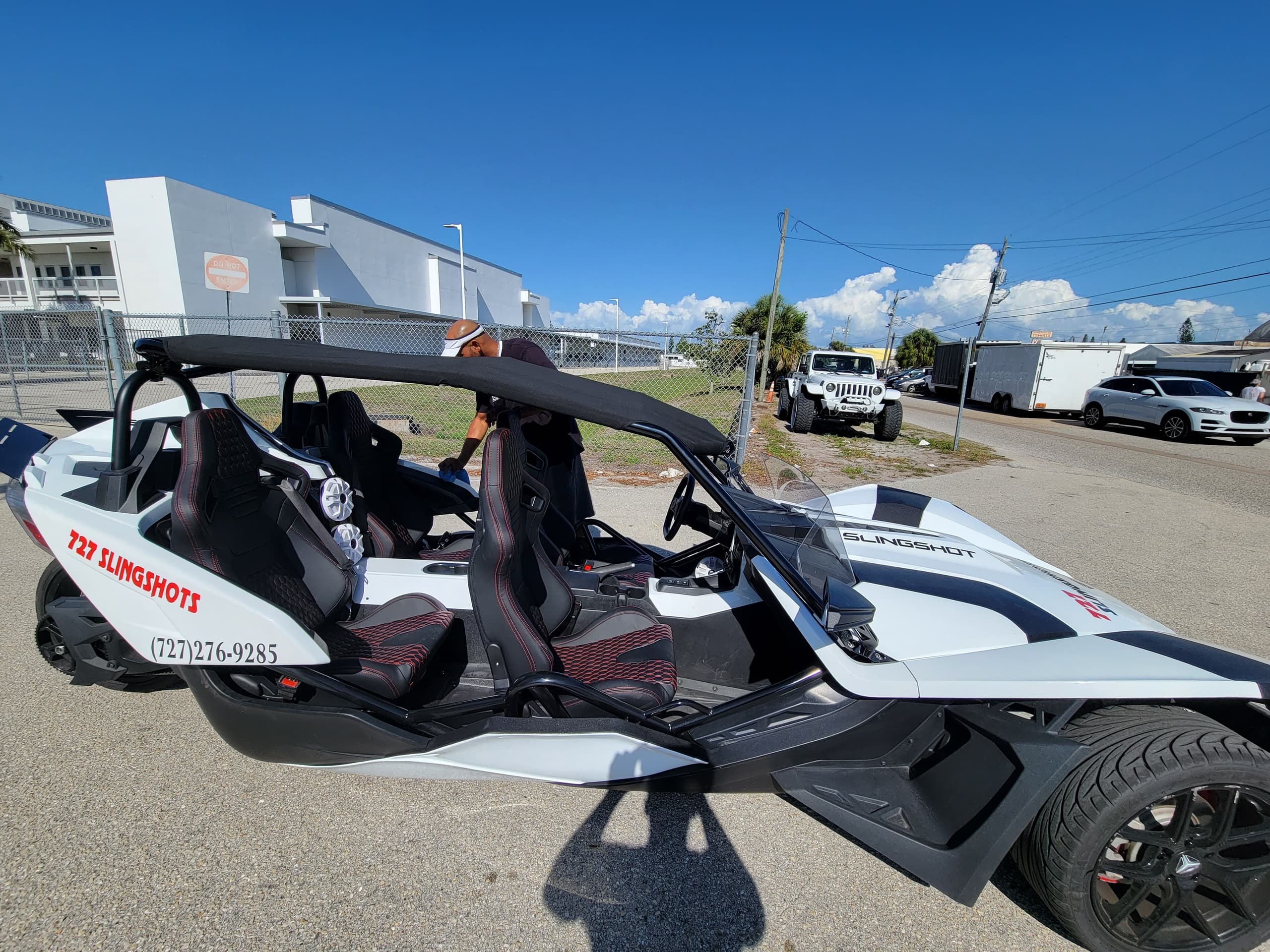 Polaris Slingshot on sunny coastal street for open-air rides