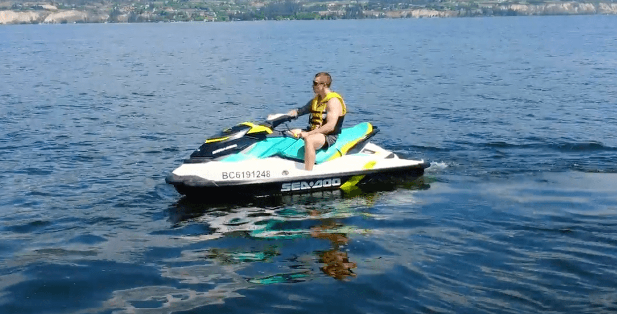 Rider on jet ski across open lake waters for fun adventure