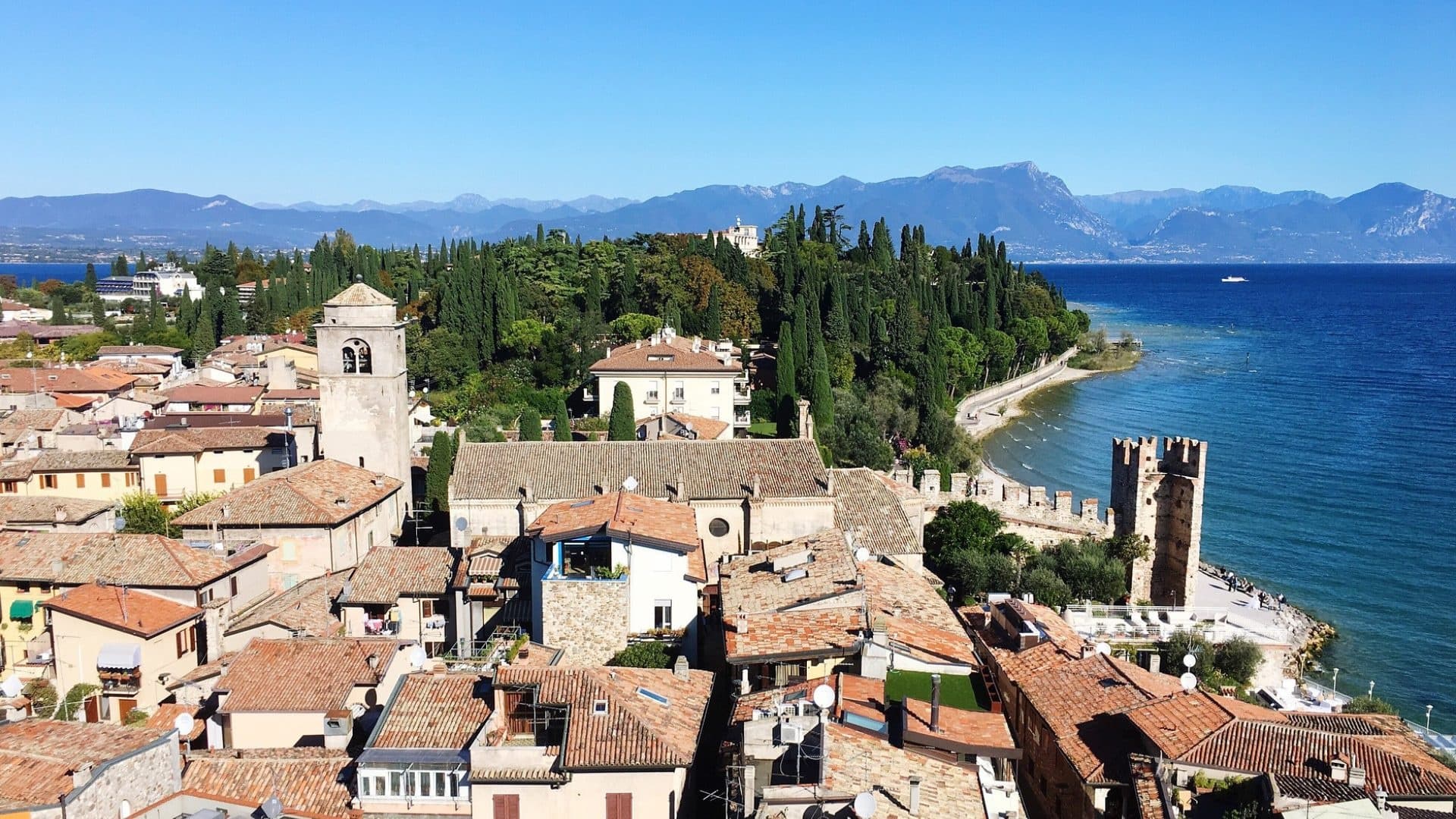 Aerial coastal town view along Mediterranean shore, seaside strolls