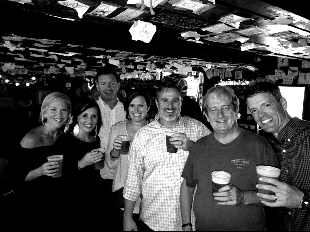 Group enjoying craft beers inside historic Savannah pub tour