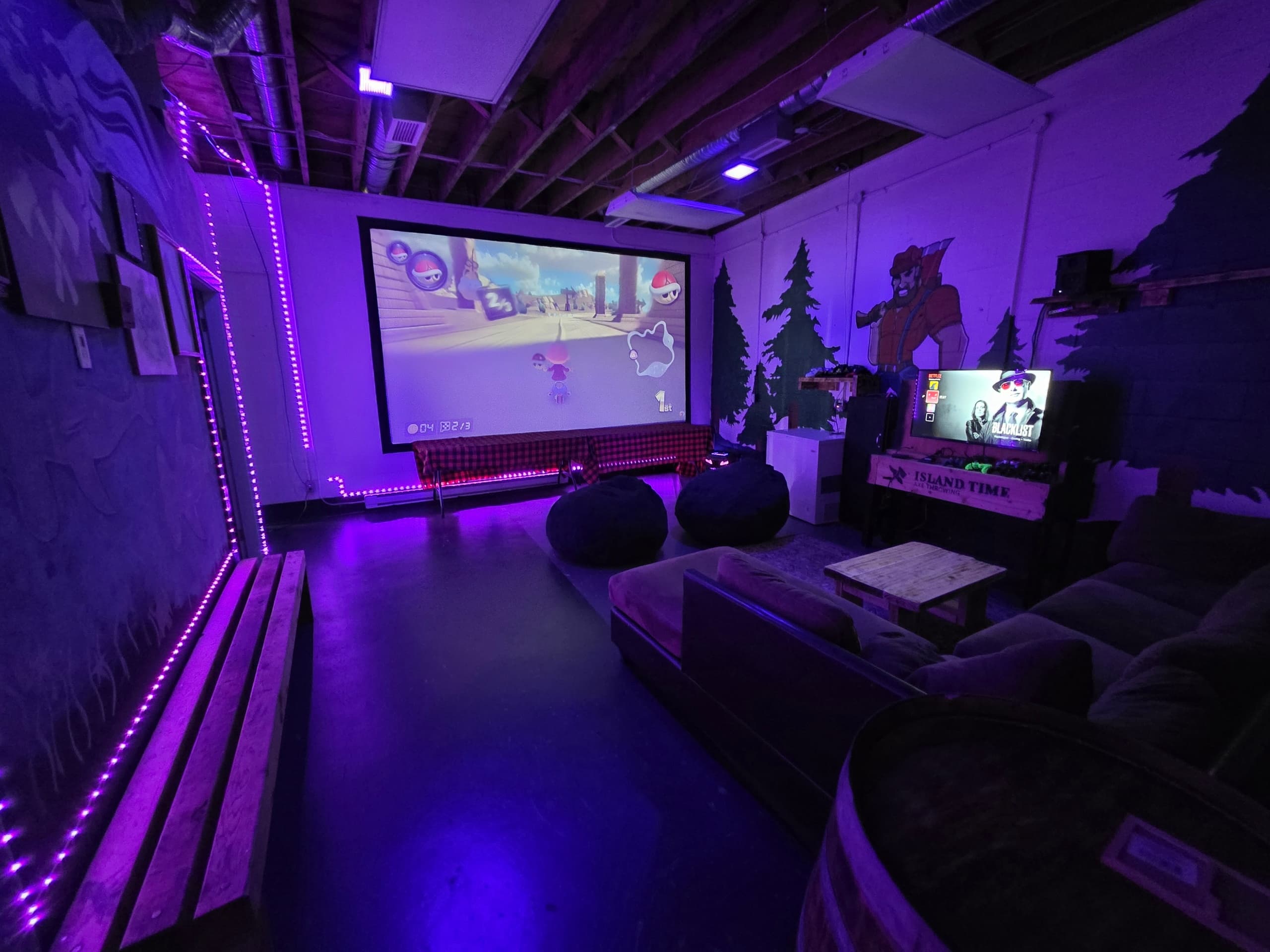 Cozy indoor lounge and arcade area at axe-throwing entertainment venue