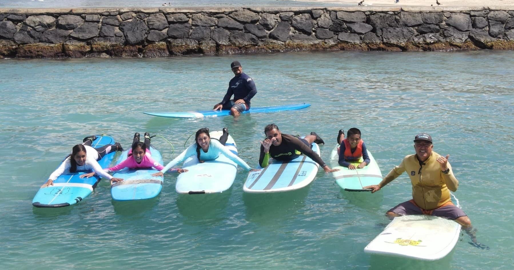 Paddleboard lesson with instructor and students in calm Hawaiian bay