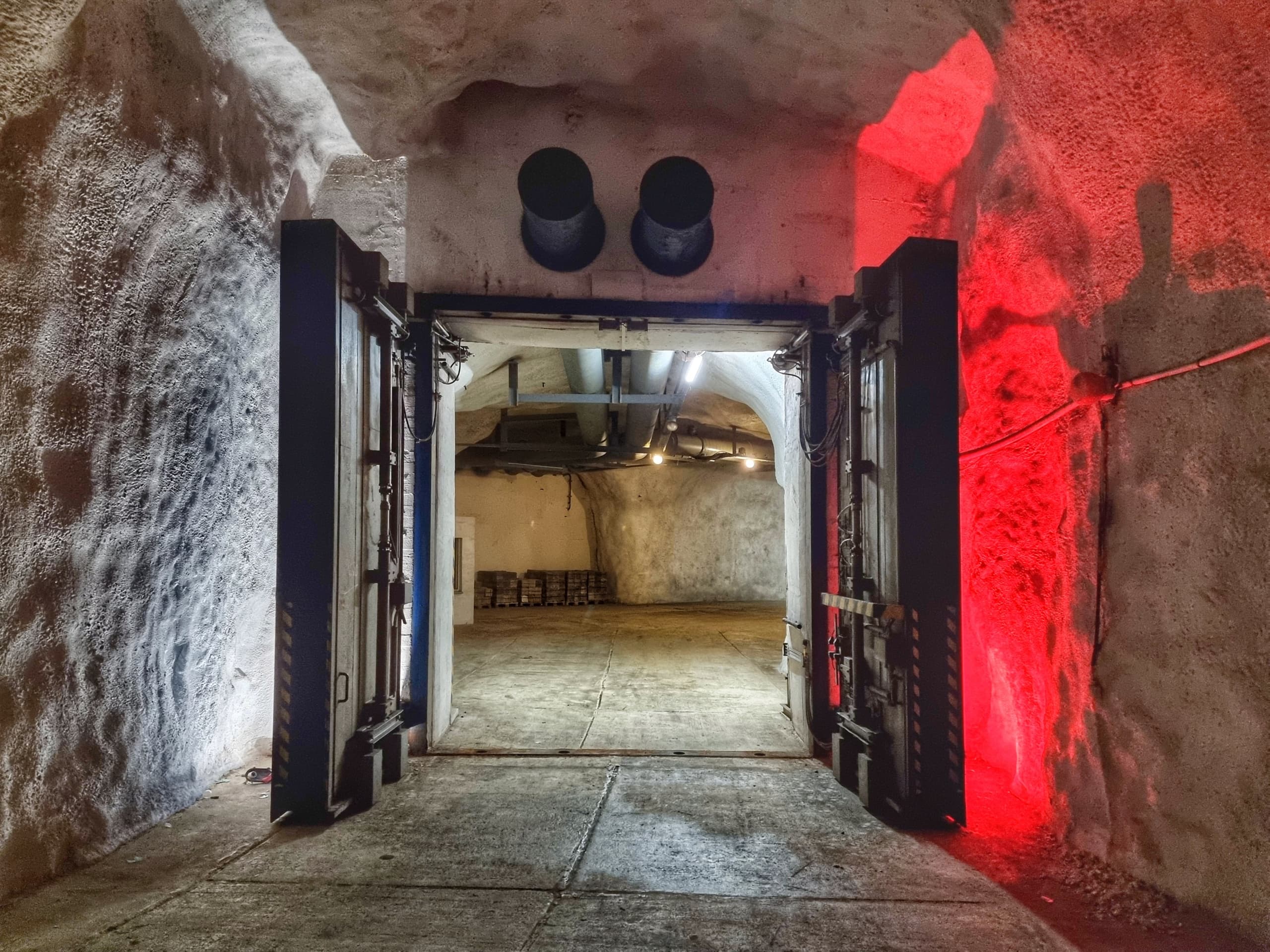 Illuminated underground cave entrance for spelunking or bunker tours