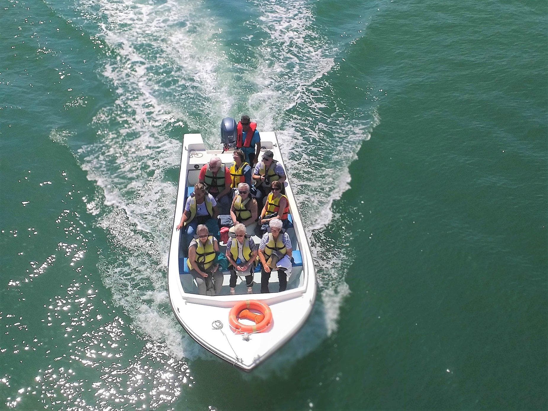 Passengers on speedboat on coastal waters during adventure trip