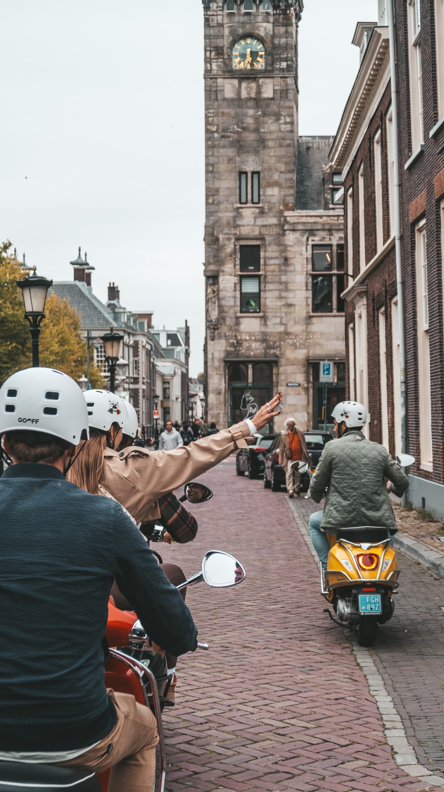 Scooters riding through narrow historic street in Utrecht center