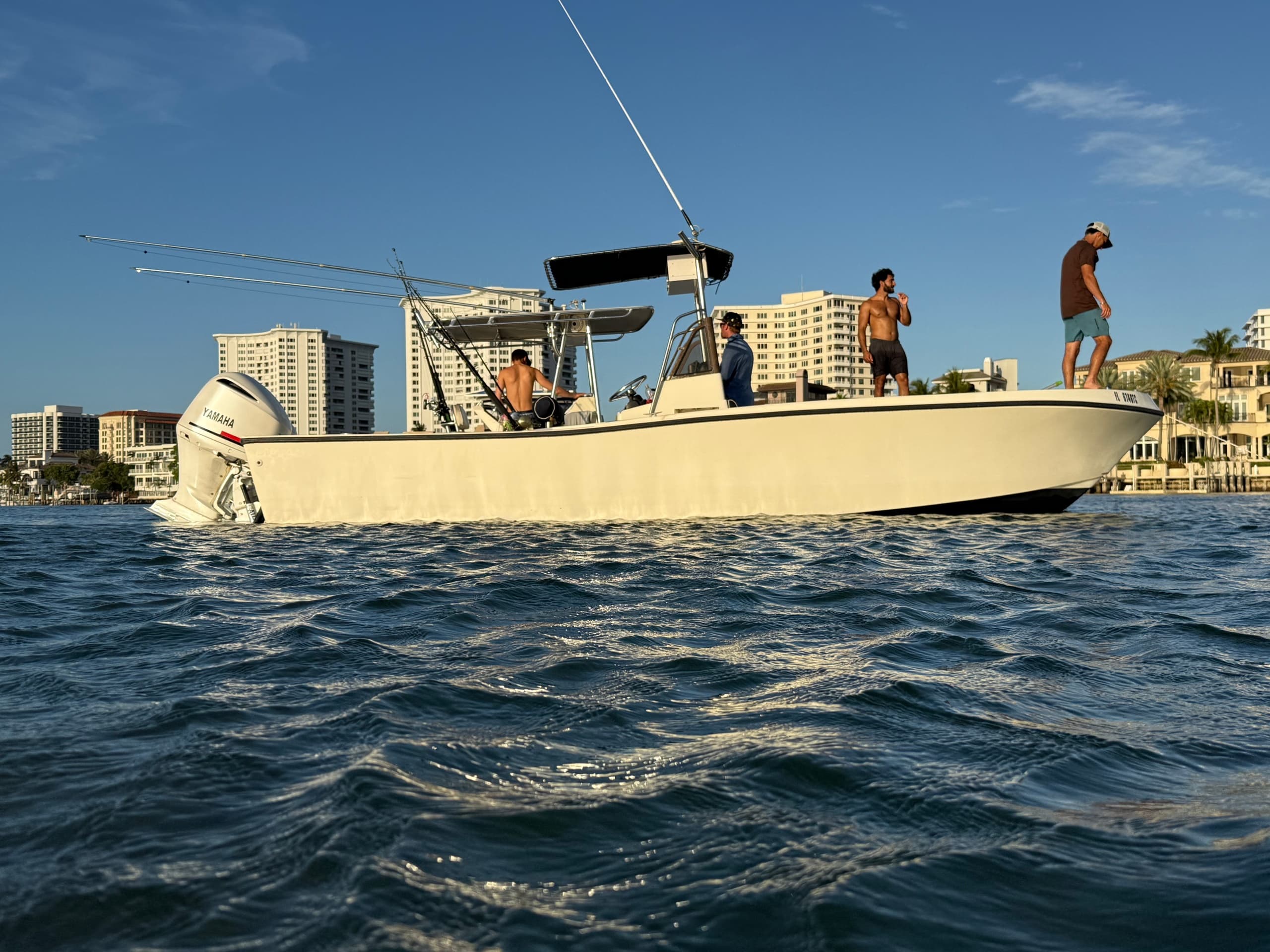 Sportfishing boat cruising offshore at golden hour, coastal view