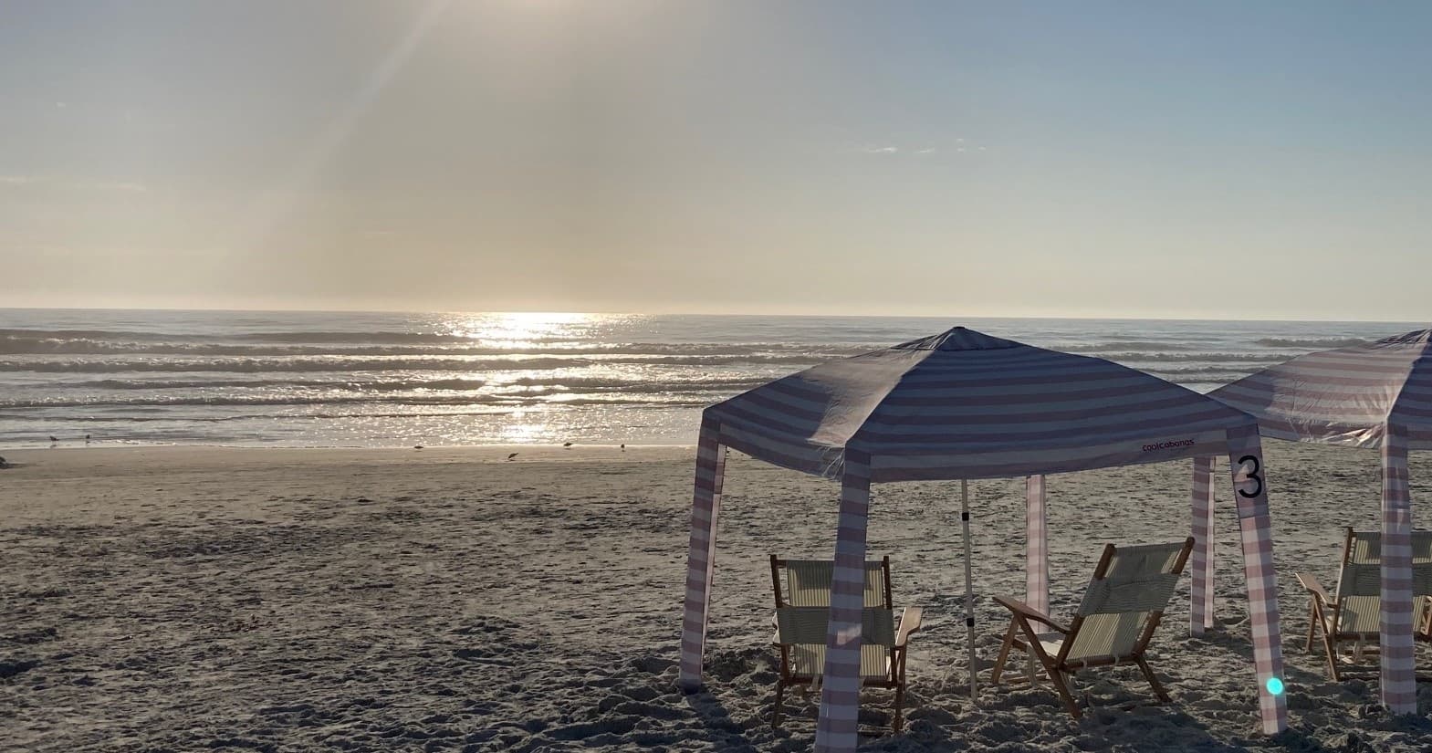 Sunset beach canopy on sandy shore for relaxed seaside rentals