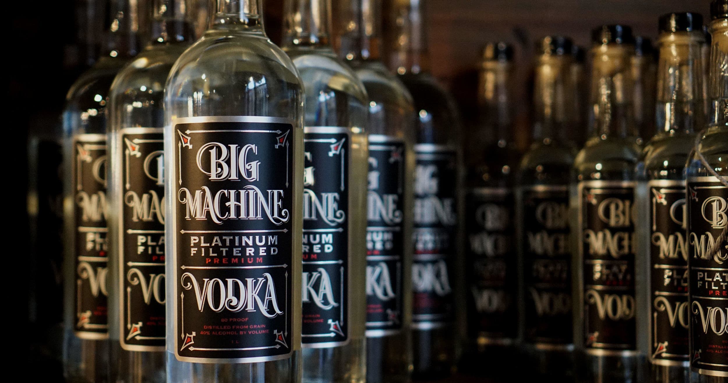 Bottles of Big Machine vodka lined on shelf in tasting room