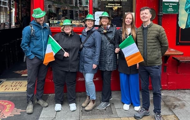 Tourists with Irish flags on a walking tour in Temple Bar Dublin