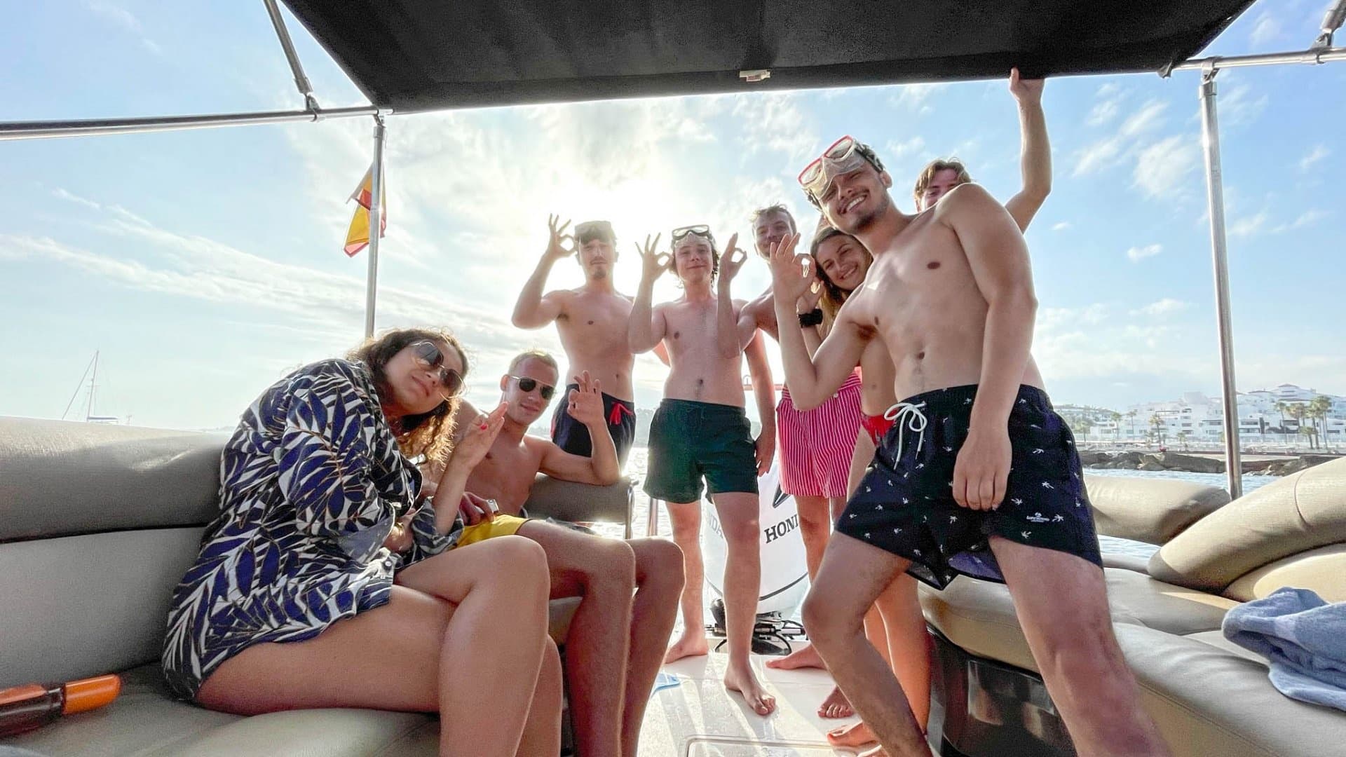 Party crew enjoying a yacht deck cruise off Marbella coast