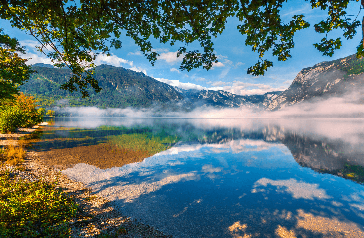 Mountain lake reflecting peaks at a serene alpine morning
