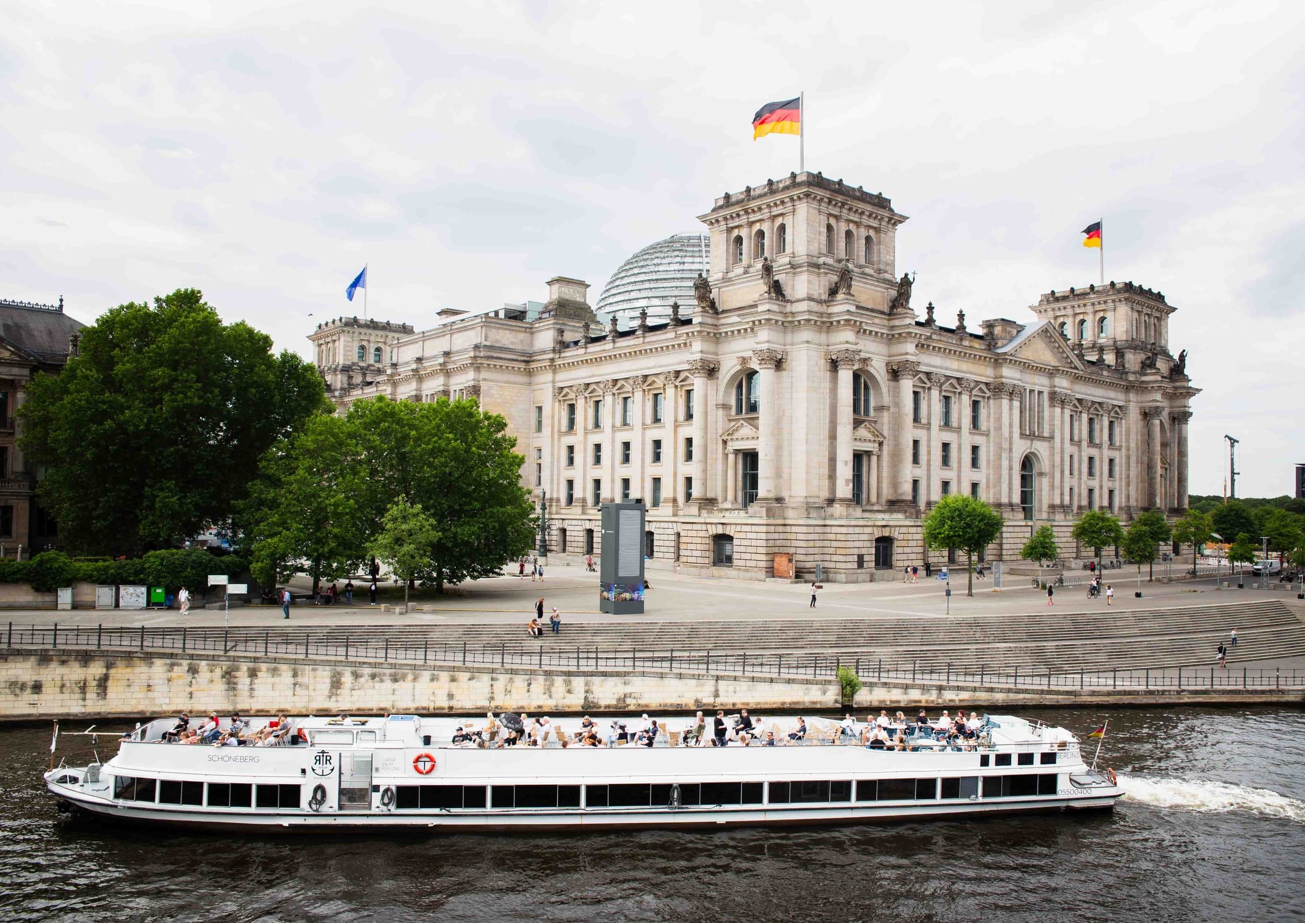 Scenic river boat passing the Reichstag along Berlin's Spree River