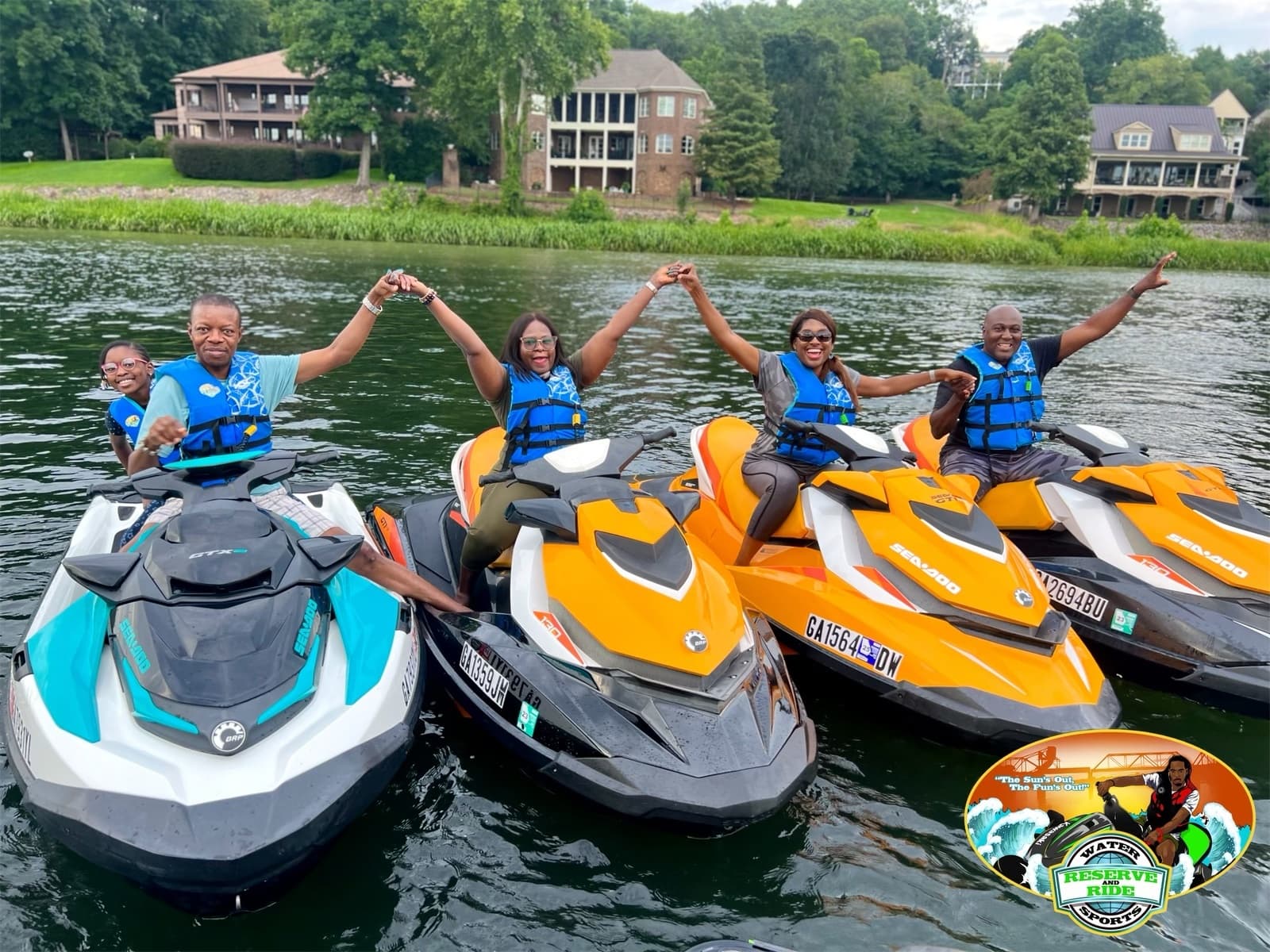 Three jet skis docked, riders linking hands on calm lake