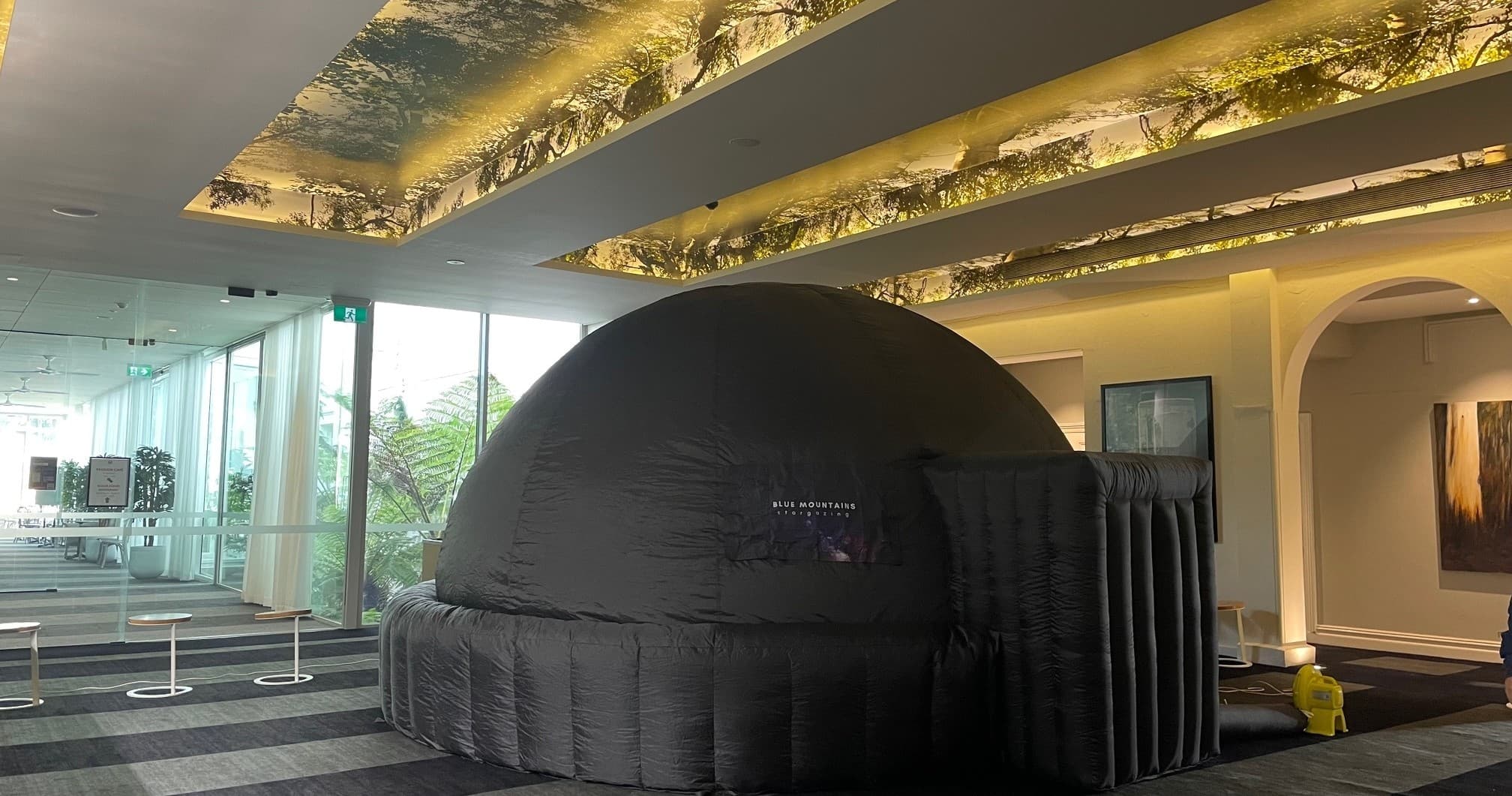 Inflatable indoor planetarium dome setup inside event lobby