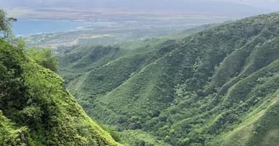 Panoramic green valley overlook showing hiking ridges and vista