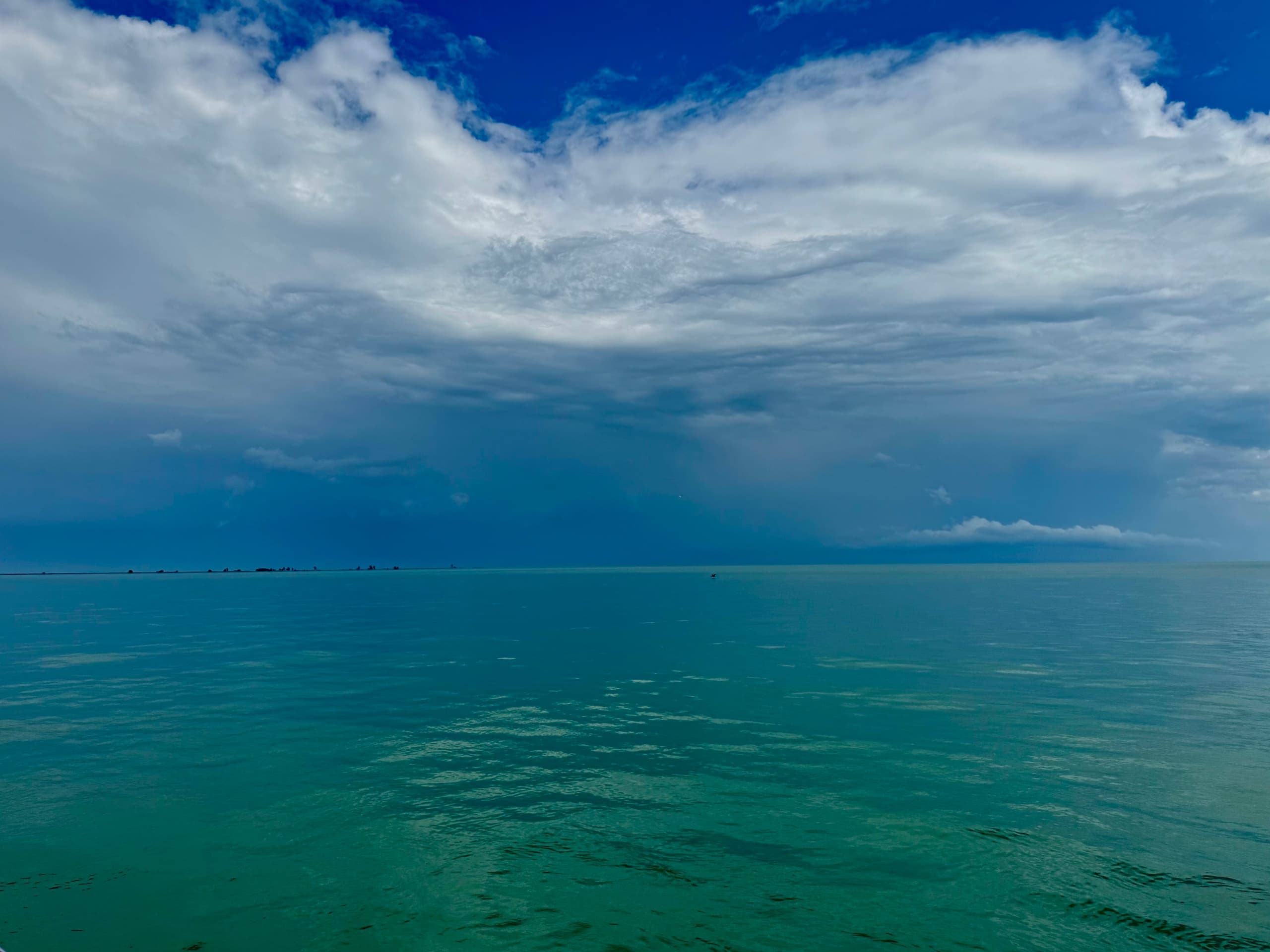 Expansive lake view with dramatic storm clouds over open water