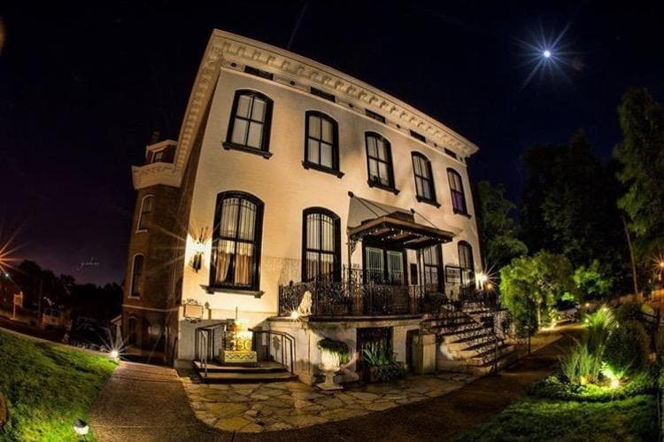 Dramatic nighttime wide-angle view of Lemp Mansion exterior