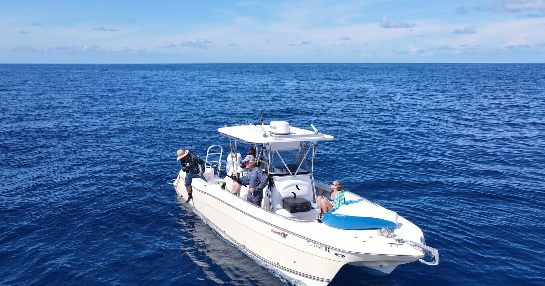 Fishing charter boat cruising calm blue open ocean, offshore