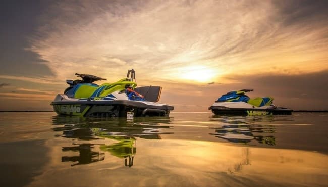 Sunset jet skis reflected on glassy water, Comox Valley shoreline
