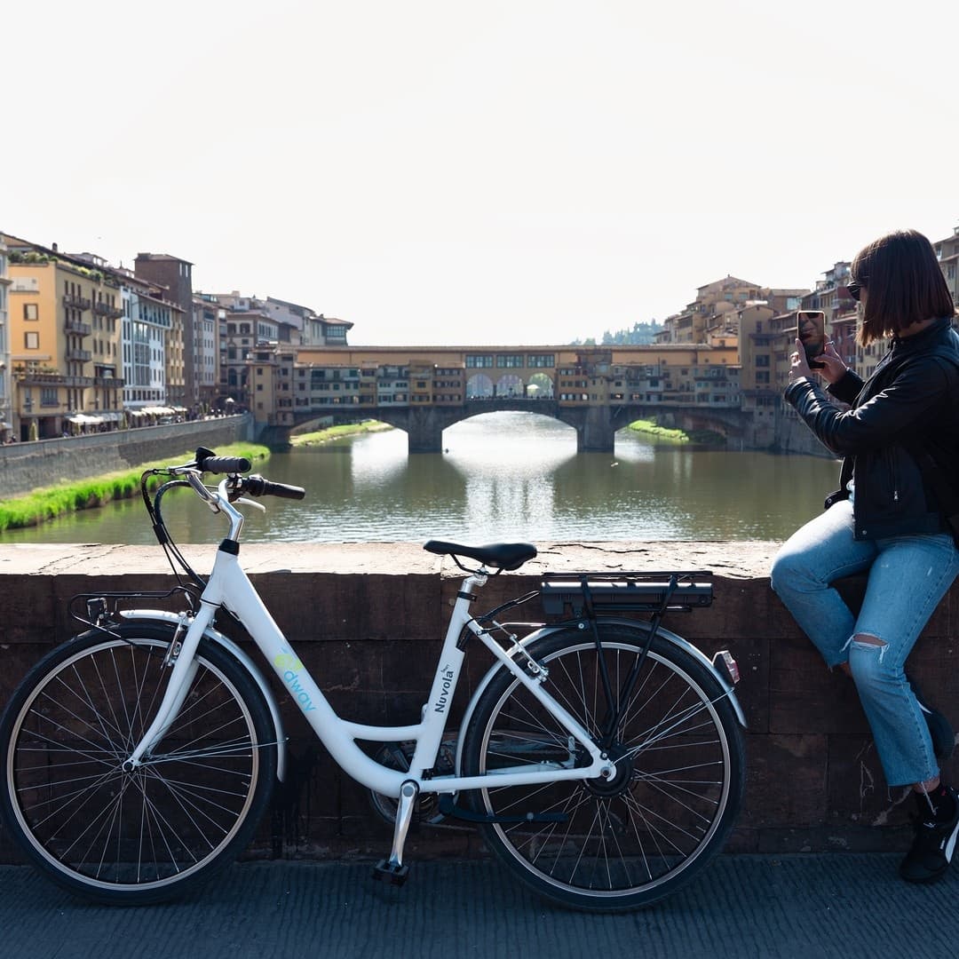 Bicycle parked by Ponte Vecchio over Arno River, Florence