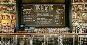 Historic bar interior with chalkboard menu and vintage bottles