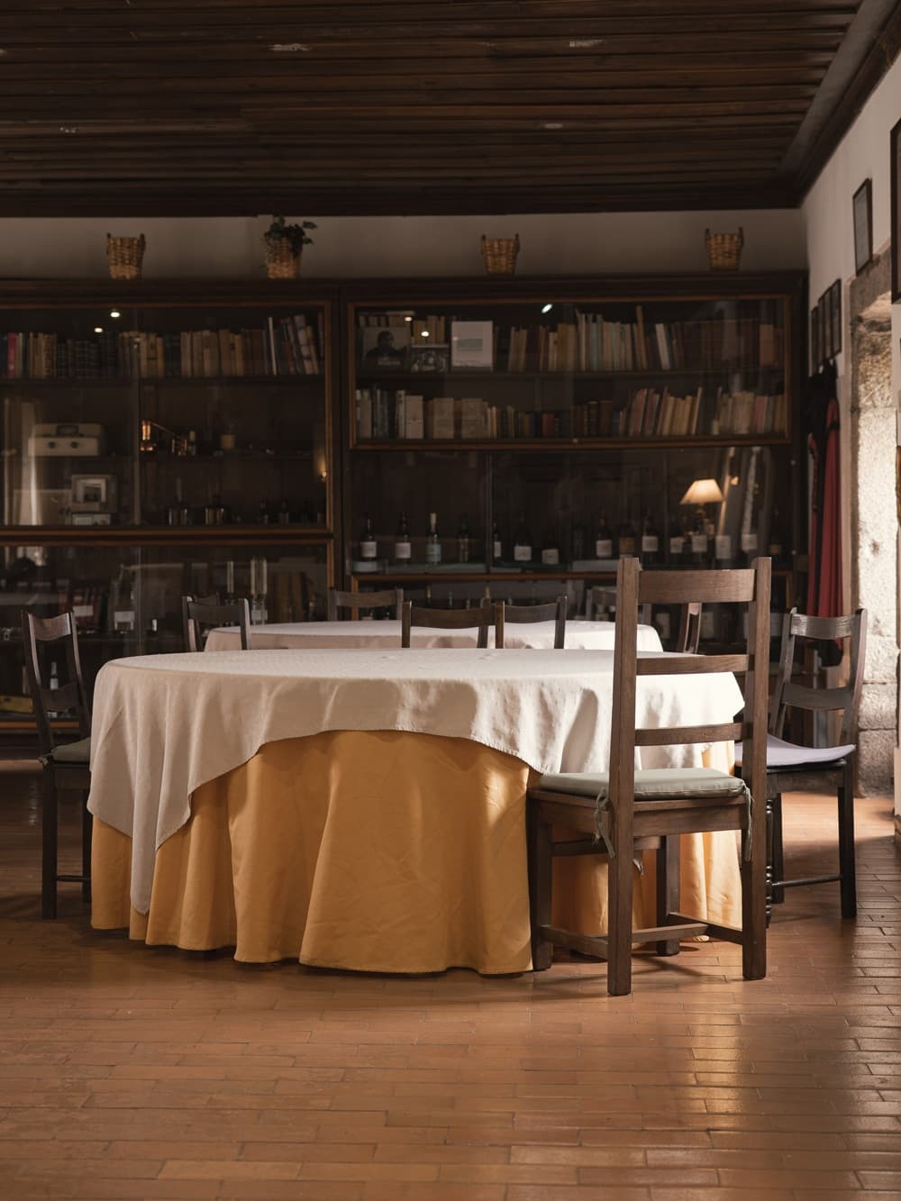 Empty rustic dining table set in historic indoor library dining room