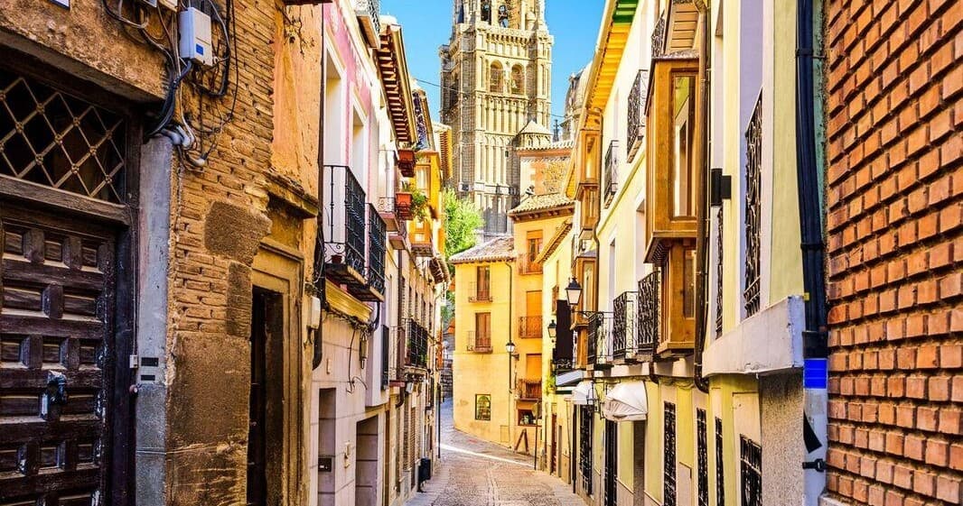 Narrow colorful alley walk through old town streets in Spain