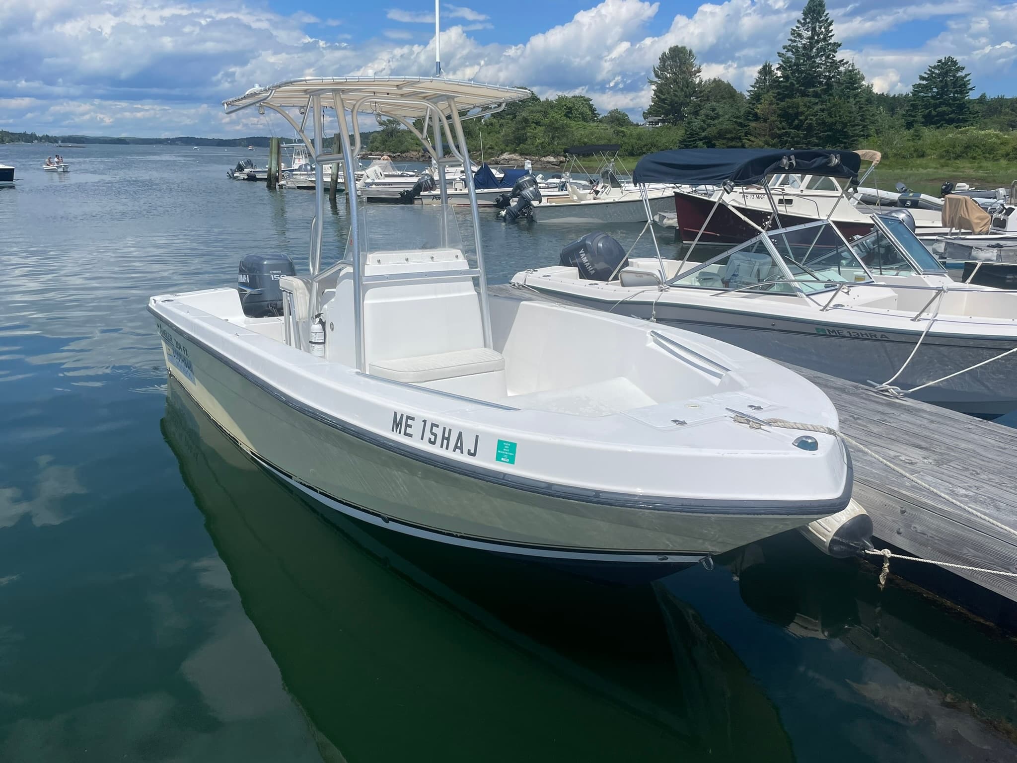 Center-console boat rental docked in coastal harbor for island cruising