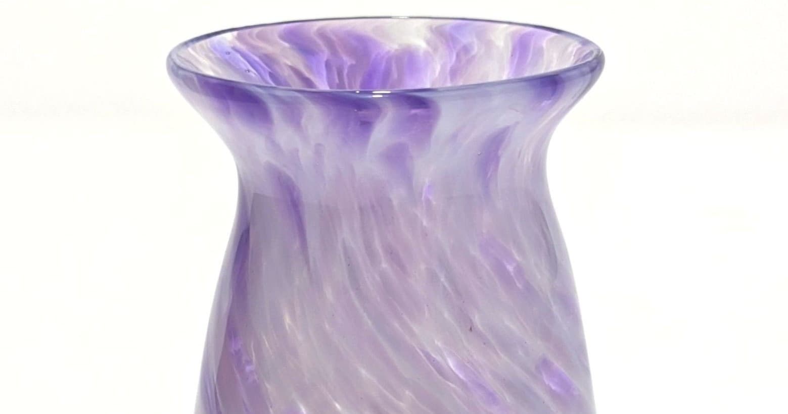 Close-up purple hand-blown glass vase with swirled pattern
