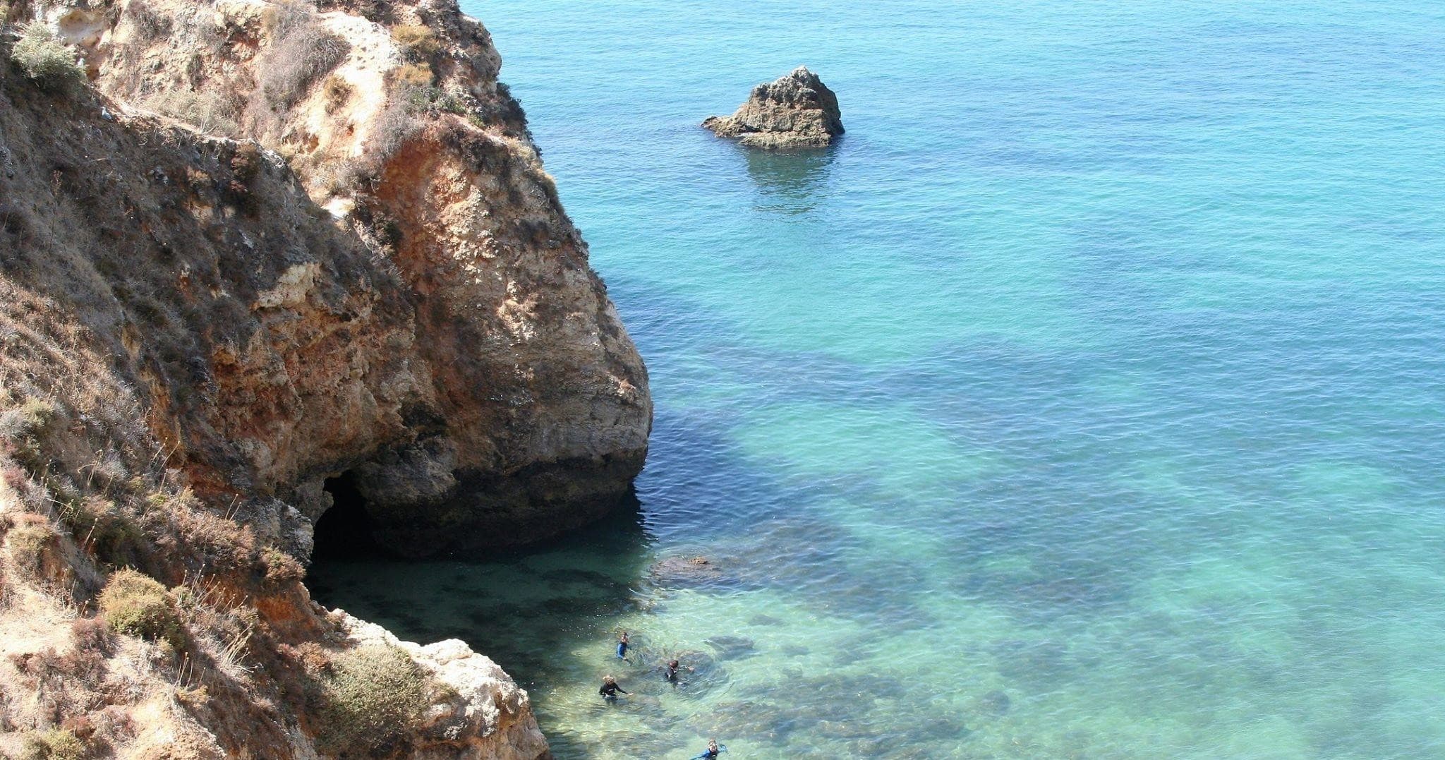 Turquoise cove and rocky shoreline on Algarve coast