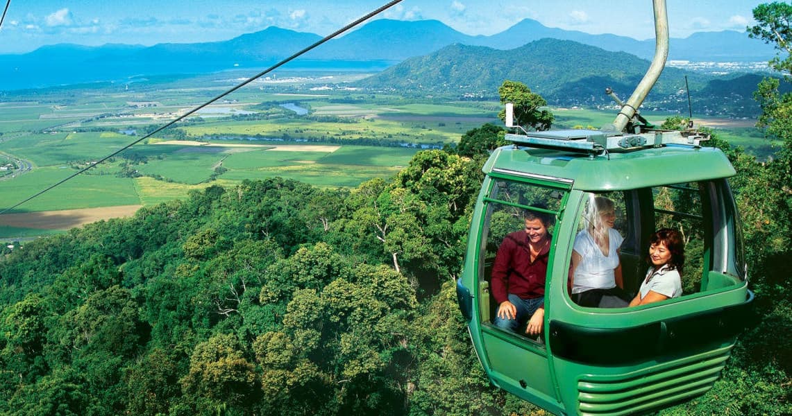 Forest canopy gondola ride over tropical mountain landscape