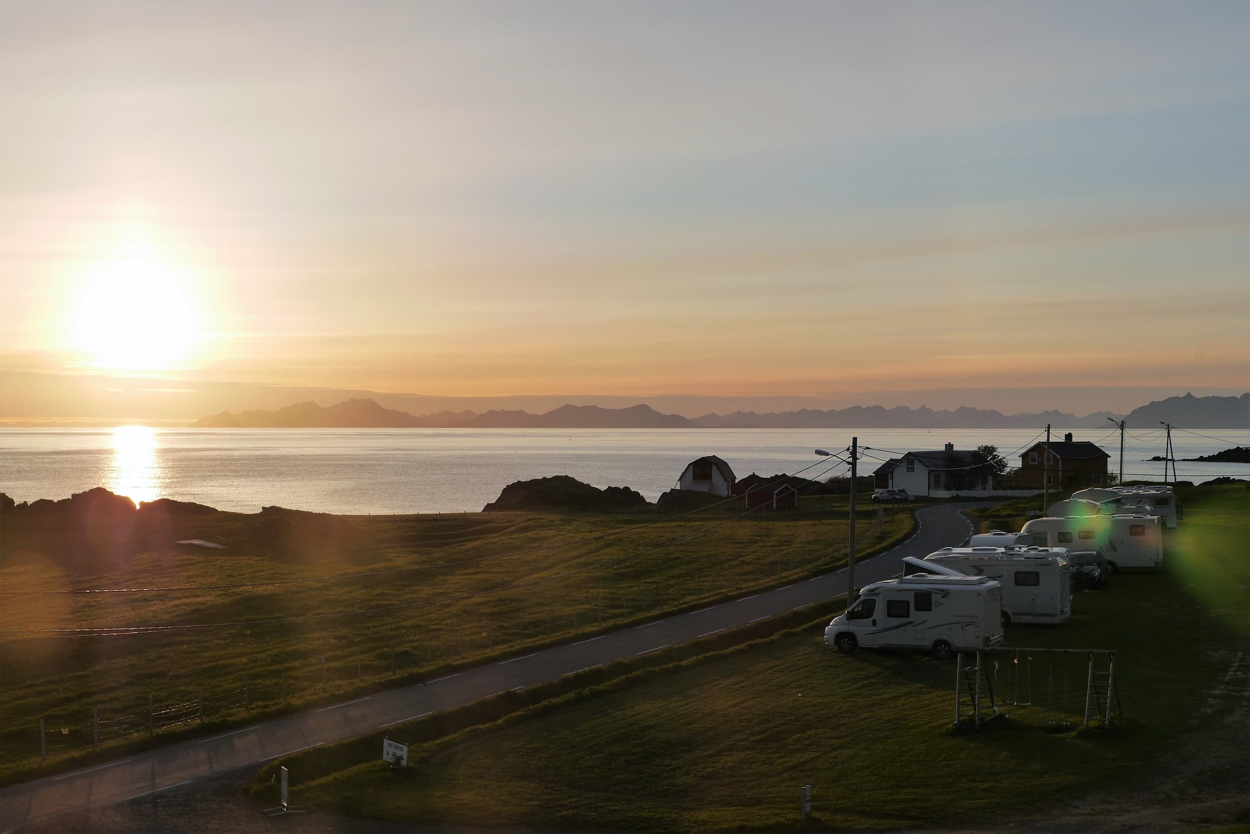 Sunrise coastal camping with RVs and ocean shoreline view