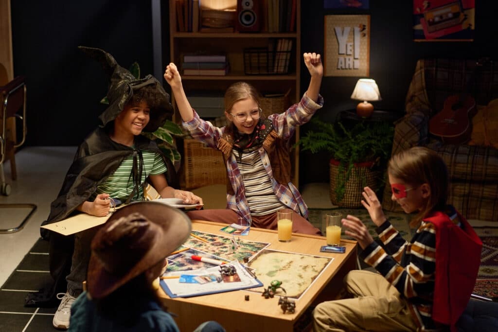 Children celebrating during indoor puzzle game at table