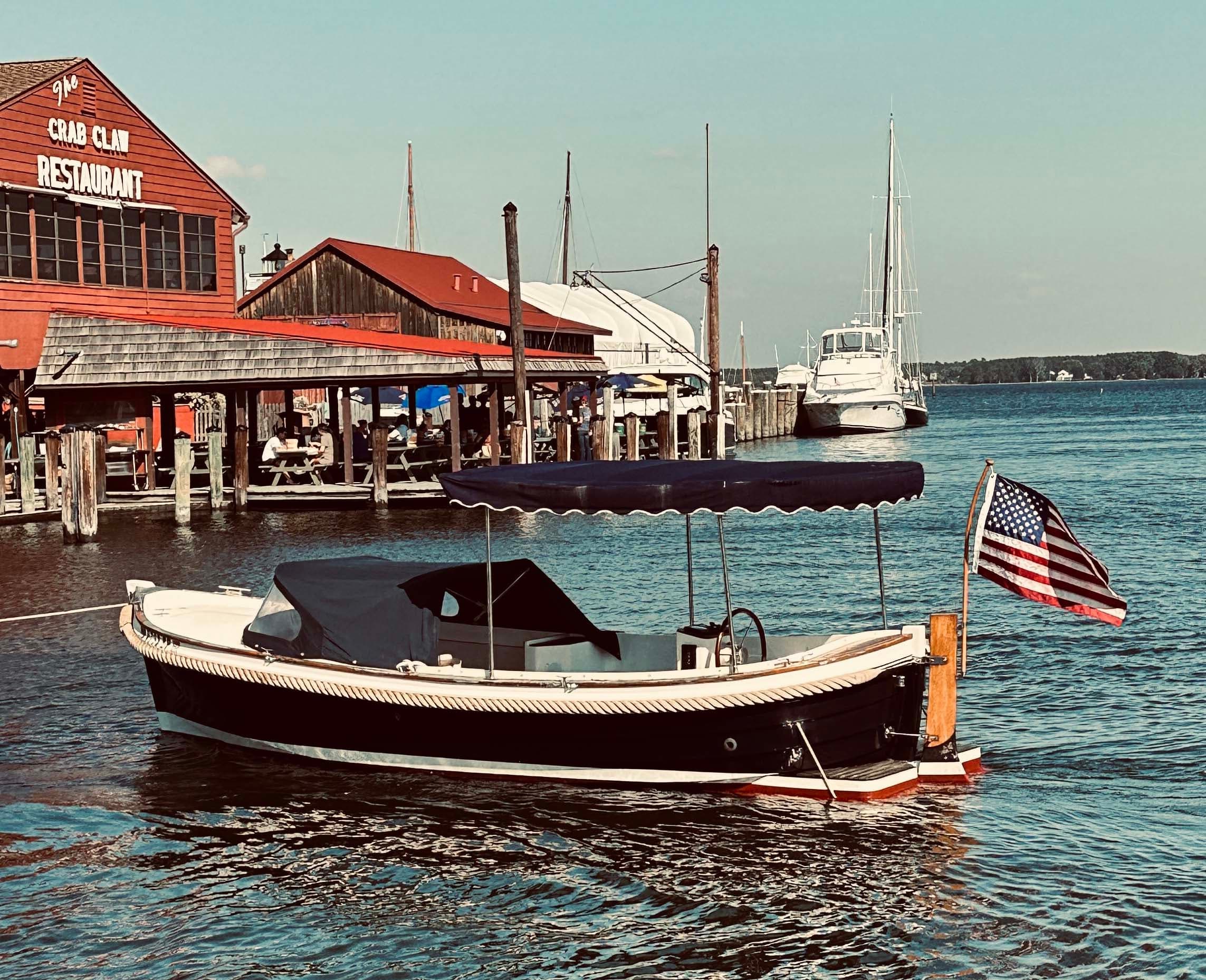 Classic wooden launch moored at a picturesque coastal marina