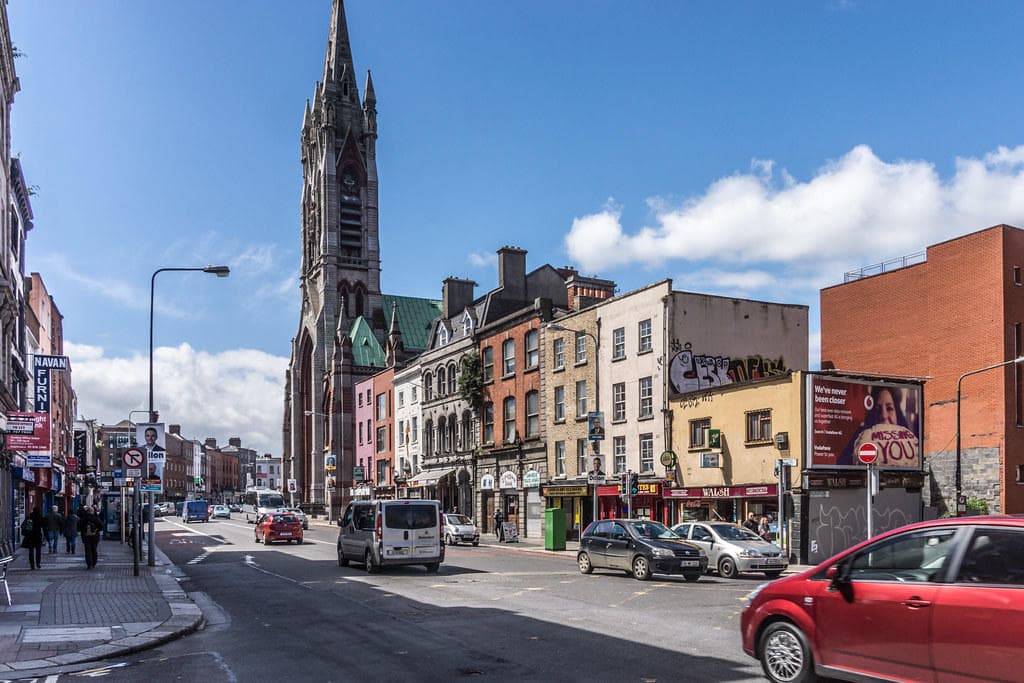 Urban street with gothic church spire in Dublin city center
