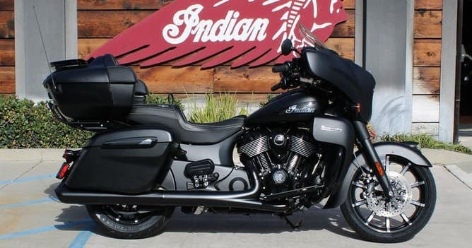Matte black Indian touring bike photographed at outdoor showroom
